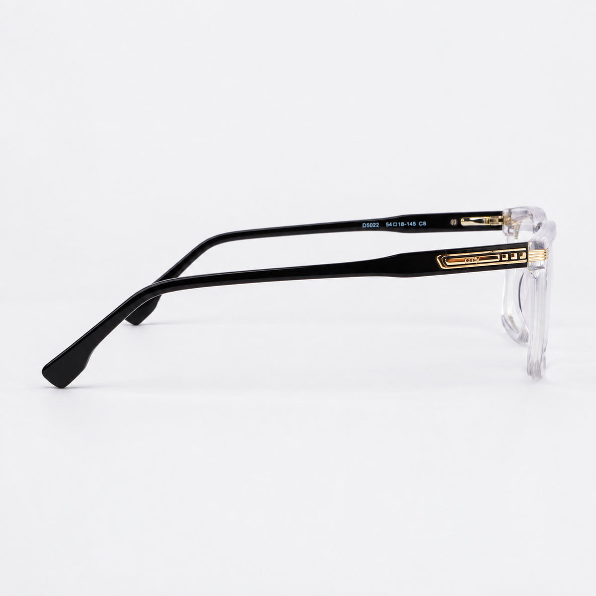 Perfil lateral de montura acetato transparente mostrando varilla negra y apliques plateados Piclek